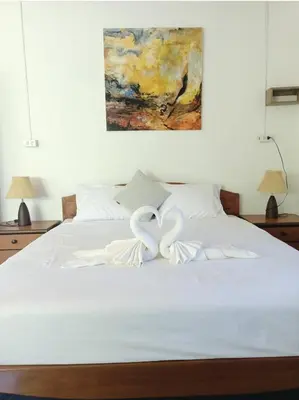 two white hearts sitting on top of a bed at House On The Bay2, Koh Yao in Ko Yao Noi