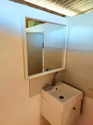 a small bathroom with a sink and a mirror at House On The Bay2, Koh Yao in Ko Yao Noi