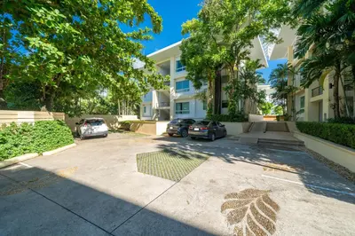 a parking lot in front of a building with cars parked at Karon Beachfront Apartment 724 in Karon Beach