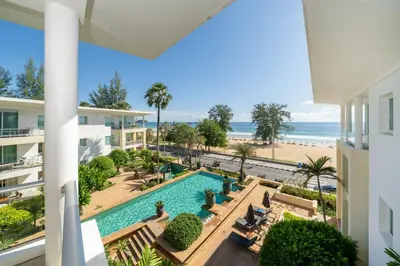 a view of the pool and beach from a building at Karon Beachfront Apartment 724 in Karon Beach