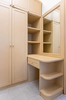 a closet with white cabinets and a desk at Chalong V pool villa in Ban Klang