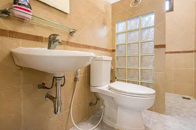 a bathroom with a toilet and a sink at Chalong V pool villa in Ban Klang
