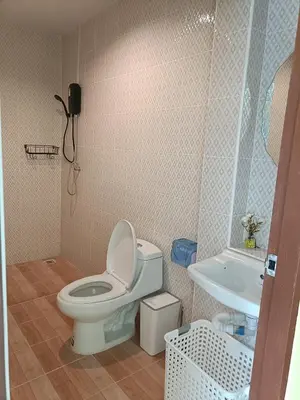 a bathroom with a toilet and a sink at Yellow house in Ban Saiyuan (1)