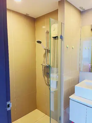 a shower with a glass door in a bathroom at 04near Shopping Malls and Naka night market in Phuket Town
