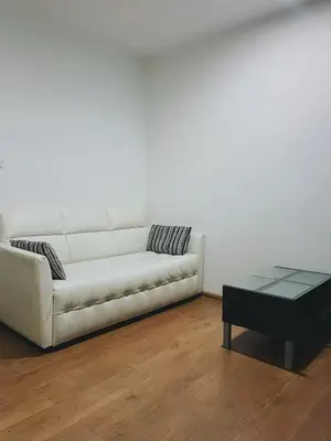 a white couch and a coffee table in a living room at 04near Shopping Malls and Naka night market in Phuket Town