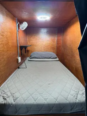 a bedroom with a bed in a small room at Green Dreams Guesthouse in Ban Lo Long