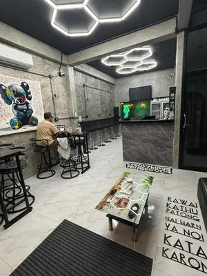 a man sitting at a bar in a restaurant at Green Dreams Guesthouse in Ban Lo Long