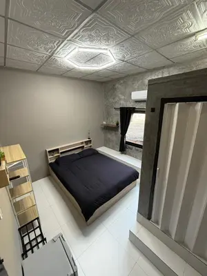 a bedroom with a bed and a mirror in it at Green Dreams Guesthouse in Ban Lo Long