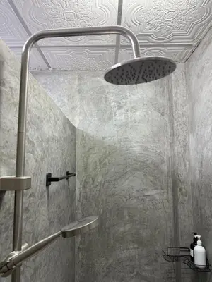 a bathroom with a shower with a shower head at Green Dreams Guesthouse in Ban Lo Long