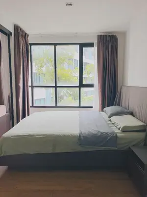 a bed in a room with a large window at 47near Shopping Malls and Naka night market in Phuket Town