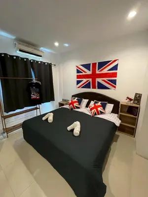 a bedroom with a black bed with a flag on the wall at DANK Hotel 420 friendly Patong Phuket in Patong Beach