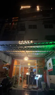 a man standing in front of a store at night at DANK Hotel 420 friendly Patong Phuket in Patong Beach