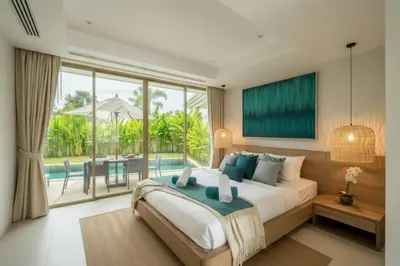 a bedroom with a large bed and a large window at Luxury 3BR Pool Villa near Blue Tree - Bang Tao in Amphoe Kathu