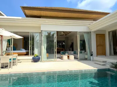 a villa with a swimming pool and a house at Luxury 3BR Pool Villa near Blue Tree - Bang Tao in Amphoe Kathu