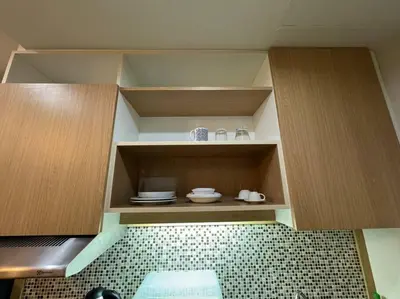 a kitchen with wooden cabinets and a tiled floor at คอนโดใกล้หาดในทอนNai Thon Beach Room A410 in Nai Thon Beach
