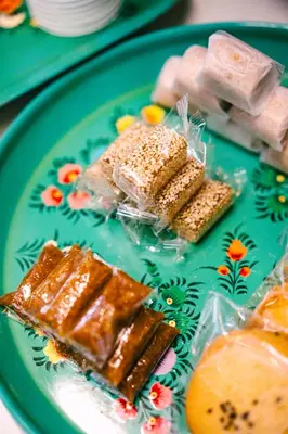 a green plate topped with different types of food at O'nya Phuket Hotel in Phuket Town