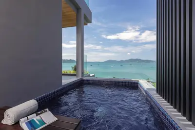 a swimming pool with a view of the ocean at X10 Seaview Suites at Panwa Beach in Panwa Beach