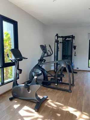 a gym with two treadmills and two ellipticals at Title V Sunny Nest Sea View 5fl Pool Gym in Rawai Beach