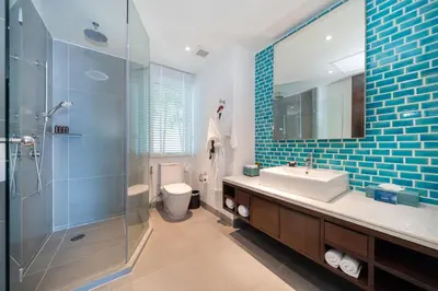 a bathroom with a toilet and a sink and a shower at Karon Beachfront Apartment 703 in Karon Beach