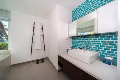 a bathroom with a sink and a mirror at Karon Beachfront Apartment 703 in Karon Beach