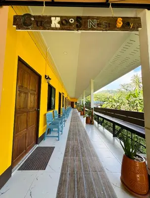 a hallway of a building with chairs and a door at Cuckoo's Nest Ao Nang in Ban Khlong Son