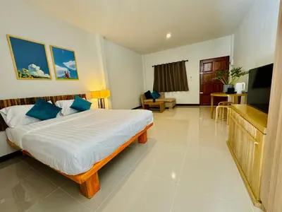 a hotel room with a bed and a television at Cuckoo's Nest Ao Nang in Ban Khlong Son