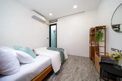 a bedroom with two beds and a table at Stylish Pool Villa in Chalong-Phuket-2 Bedroom in Ban Suan