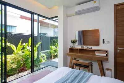a bedroom with a bathroom with a sink and a desk at Stylish Pool Villa in Chalong-Phuket-2 Bedroom in Ban Suan