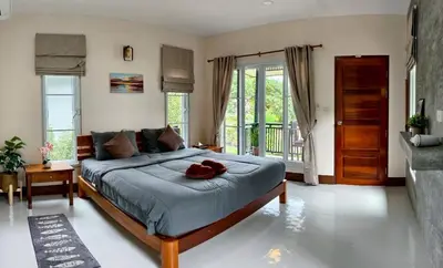 a bedroom with a large bed with a bowl on it at Picha house Kohyaonoi in Ban Laem Sai