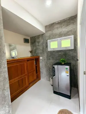 a kitchen with a stainless steel refrigerator in a room at Picha house Kohyaonoi in Ban Laem Sai