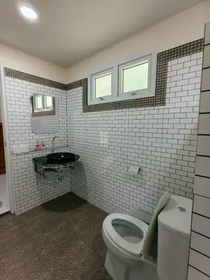a bathroom with a toilet and a sink at Picha house Kohyaonoi in Ban Laem Sai