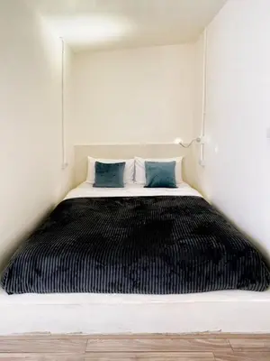 a black and white bed in a room at Purr in Phuket Town
