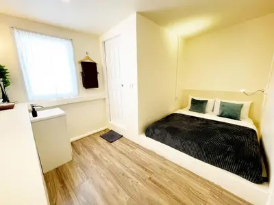 a bedroom with a bed with a black blanket at Purr in Phuket Town