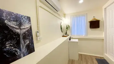 a hallway with a painting on the wall and a window at Purr in Phuket Town