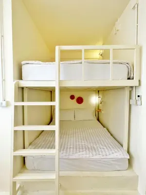 a small room with white bunk beds at Purr in Phuket Town