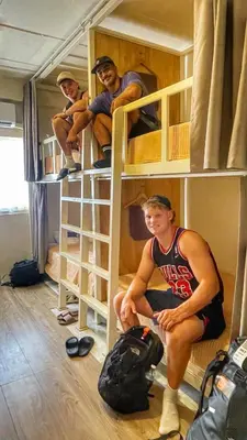 a group of people sitting in bunk beds at Purr in Phuket Town