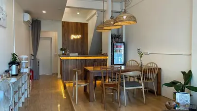a dining room with a table and chairs at Purr in Phuket Town