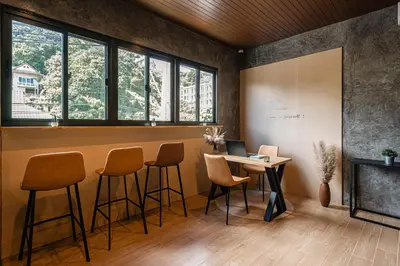 an office with a bar with chairs and a desk at Mitsu Guesthouse in Karon Beach