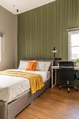 a bedroom with a bed and a desk and a chair at The Rich Villas House Pool Chalong Robinson in Ban Suan