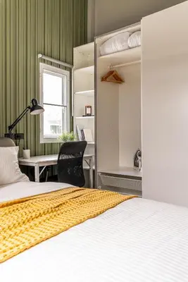 a bedroom with a bed and a desk with a chair at The Rich Villas House Pool Chalong Robinson in Ban Suan