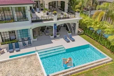 an aerial view of a house with a swimming pool at Villa Viola 7 Bedroom, Fully Staffed, on the Golf Course in Laguna Phuket