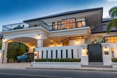 a white house with a balcony and a driveway at Villa Viola 7 Bedroom, Fully Staffed, on the Golf Course in Laguna Phuket