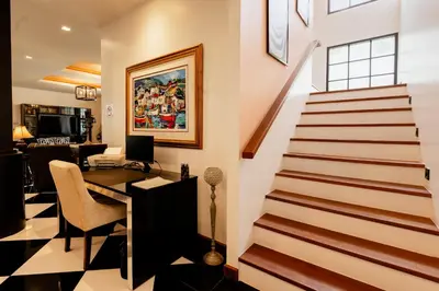 a room with a staircase and a desk with a computer at Villa Viola 7 Bedroom, Fully Staffed, on the Golf Course in Laguna Phuket