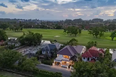 an aerial view of a golf course with a house at Villa Viola 7 Bedroom, Fully Staffed, on the Golf Course in Laguna Phuket