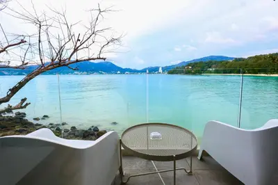 a view of a lake with a table and chairs at Tri Trang Beachfront Apartments with Stunning Views in Patong Beach
