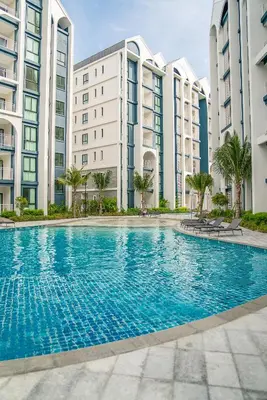 a swimming pool in front of some apartment buildings at Title Halo Vitamin Sea 40m2 King Bed Naiyang in Nai Yang Beach