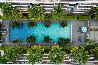 an overhead view of a swimming pool with palm trees at C251 Beachfront gym Sauna 7 Swimming Pool in Rawai Beach