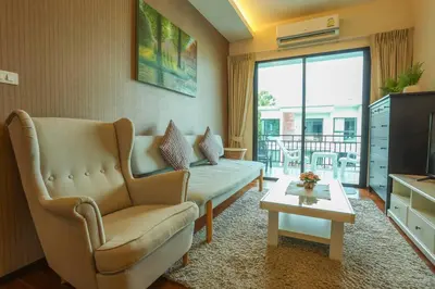a living room with a couch and a table at C251 Beachfront gym Sauna 7 Swimming Pool in Rawai Beach