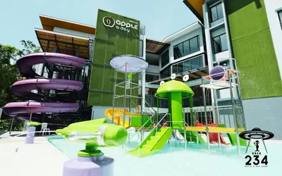 a playground in front of a building with colorful slides at The Capuchin Hotel Krabi, Ao Nang Beach in Ao Nang Beach