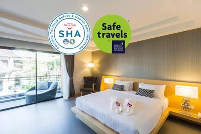 a hotel room with a bed with two shoes on it at The Capuchin Hotel Krabi, Ao Nang Beach in Ao Nang Beach